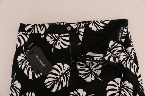 White and black leaf print cotton stretch slim pants by Dolce & Gabbana, featuring a tailored fit and stylish leaf pattern.
