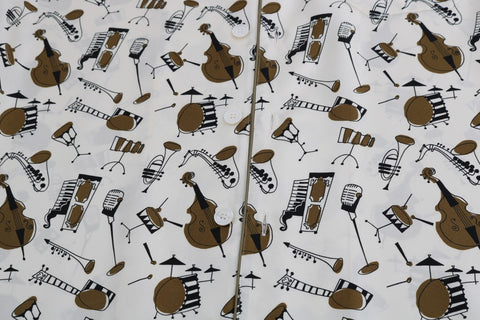 White silk Jazz Motive print shirt by Dolce & Gabbana, featuring a stylish pattern and classic collar in a close-up view.