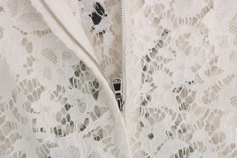 White lace blouse with crystal embellishments by Dolce & Gabbana, featuring intricate lace details and elegant design.