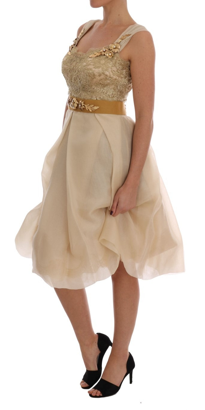 Gold silk dress by Dolce & Gabbana with crystal embellishments, featuring a flowing silhouette and elegant design.