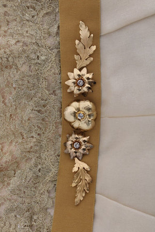 Gold silk dress with crystal embellishments by Dolce & Gabbana, featuring elegant draping and intricate detailing.