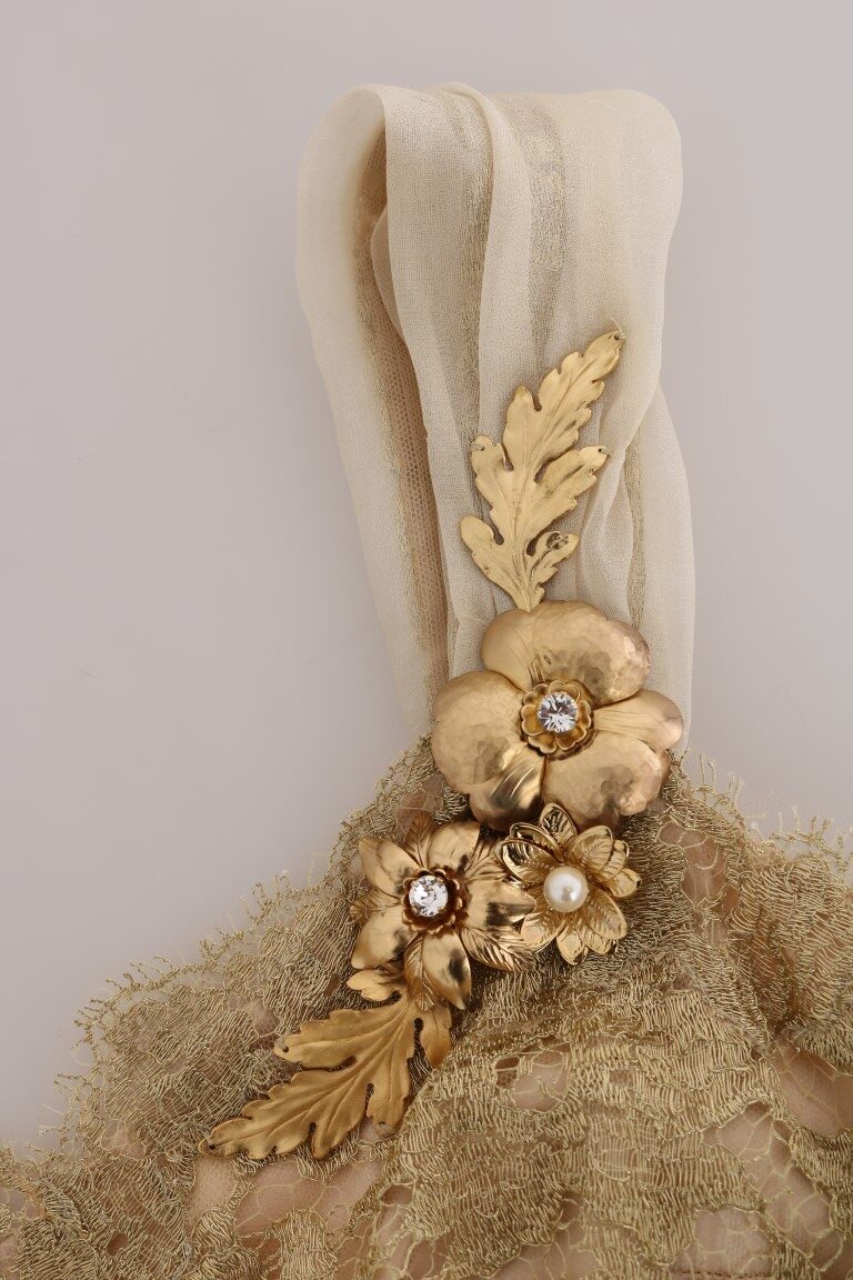 Gold silk dress with crystal embellishments by Dolce & Gabbana, featuring a flowing design and intricate detailing.