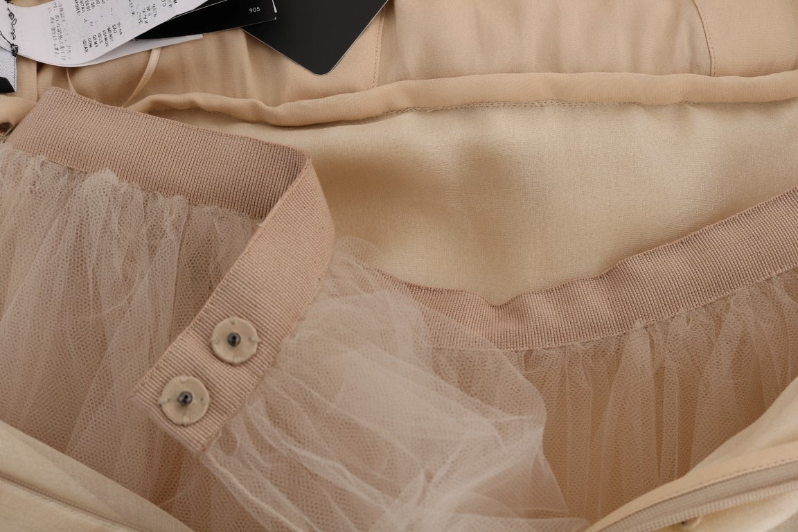 Gold silk dress with crystal embellishments by Dolce & Gabbana, featuring a sleek, elegant design and intricate detailing.