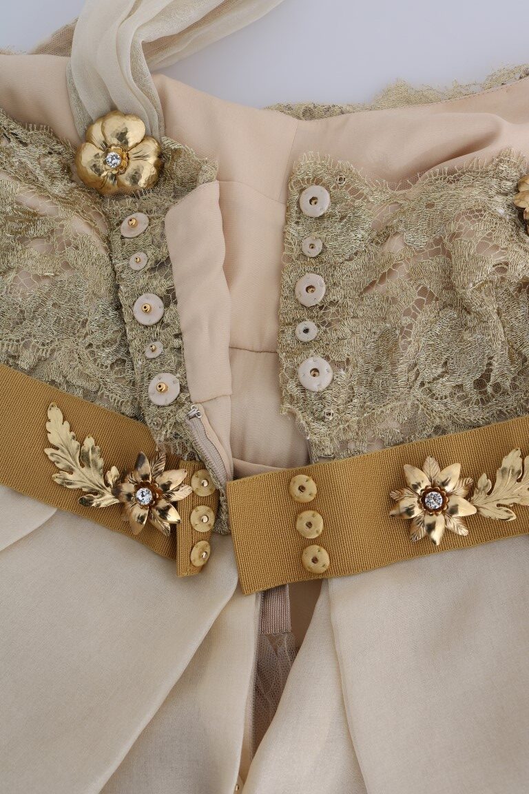 Gold silk dress with crystal embellishments by Dolce & Gabbana, featuring elegant draping and intricate beadwork.