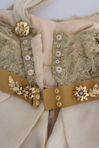 Gold silk dress with crystal embellishments by Dolce & Gabbana, featuring elegant draping and intricate beadwork.