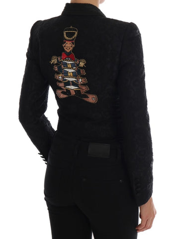 Black brocade blazer jacket by Dolce & Gabbana, featuring intricate woven fabric and tailored fit, displayed on a hanger.