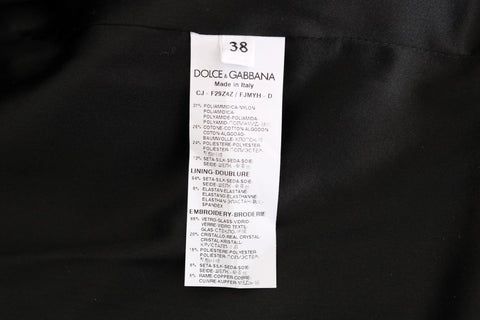 Black brocade blazer jacket by Dolce & Gabbana, tailored fit with intricate floral pattern, front buttons, and classic lapel collar.