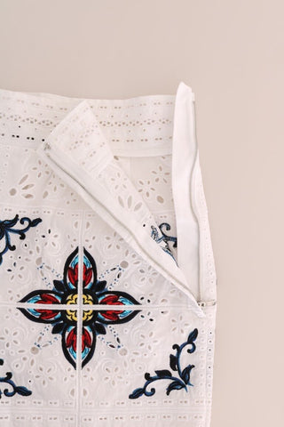 Dolce & Gabbana Mulicolor Majolica Cutout Capri Pants with vibrant colorful patterns and cutout details, shown from a side angle.