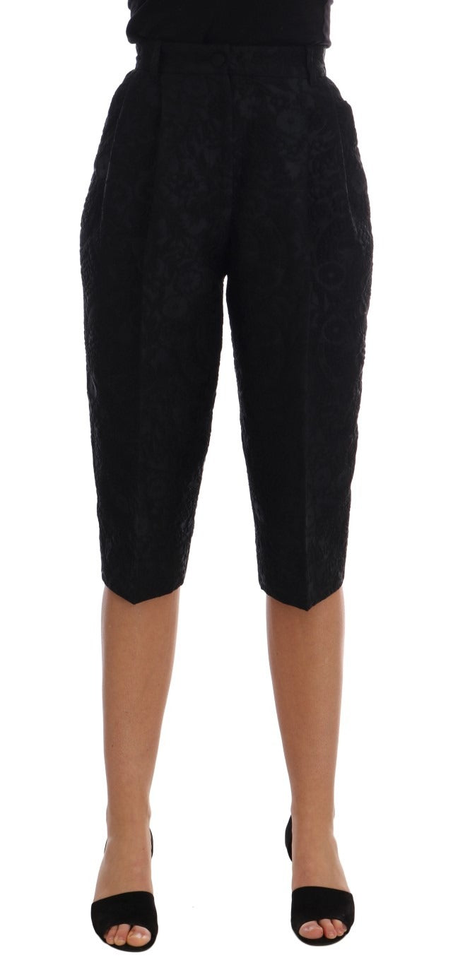 Black brocade high waist capri shorts by Dolce & Gabbana with intricate floral patterns and tailored fit.