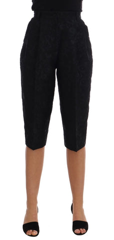 Black brocade high waist capri shorts by Dolce & Gabbana with intricate floral patterns and tailored fit.