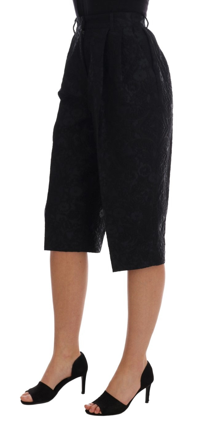 Black brocade high waist capri shorts by Dolce & Gabbana with intricate floral pattern and tailored fit.