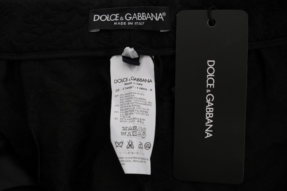Black brocade high-waist Capri shorts by Dolce & Gabbana, featuring intricate fabric patterns and a tailored fit.