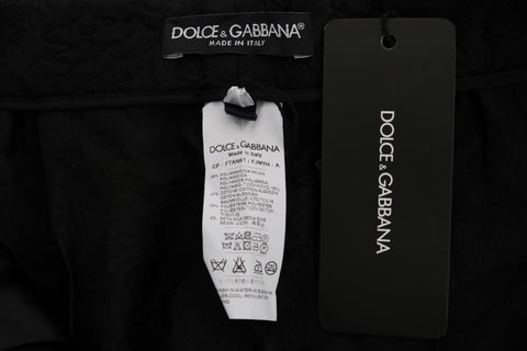 Black brocade high-waist Capri shorts by Dolce & Gabbana, featuring intricate fabric patterns and a tailored fit.