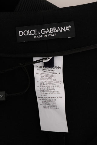Black wool stretch crystal pants by Dolce & Gabbana, showing a close-up of the tailored fit with crystal embellishments.