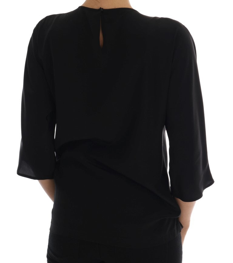 Black silk fairy tale top with crystal embellishments from Dolce & Gabbana, featuring a flowing, elegant blouse with intricate detailing.
