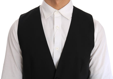Black wool silk vest by Dolce & Gabbana, shown on a hanger, highlighting its smooth fabric and tailored fit.