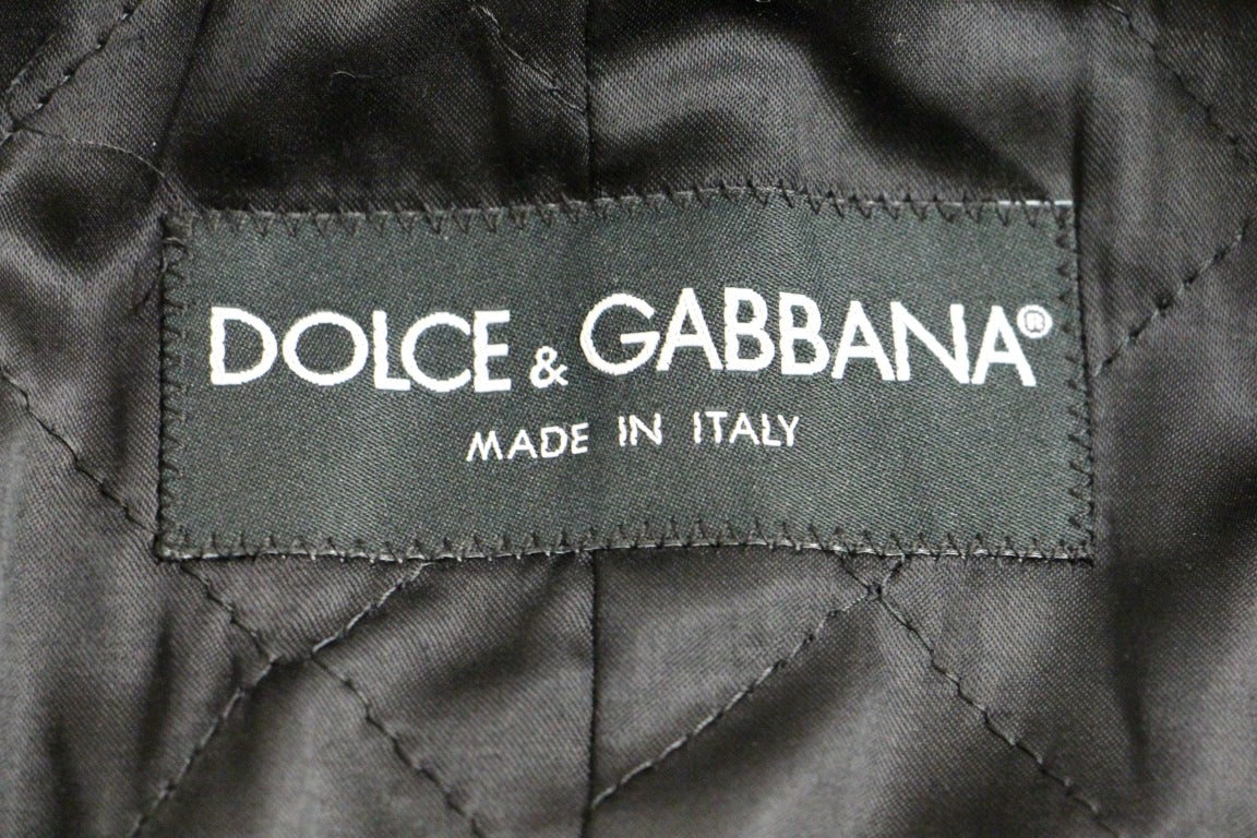 Gray double-breasted coat jacket by Dolce & Gabbana, featuring tailored fit and classic design, displayed on a hanger.