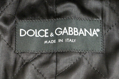 Gray double-breasted coat jacket by Dolce & Gabbana, featuring tailored fit and classic design, displayed on a hanger.
