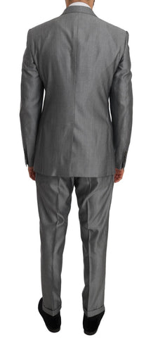 Black stretch crystal bee slim fit suit by Dolce & Gabbana, featuring tailored jacket and matching trousers with crystal bee details.