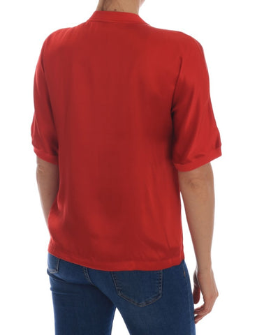 Red silk blouse by Dolce & Gabbana featuring orange floral patterns and crystal embellishments.