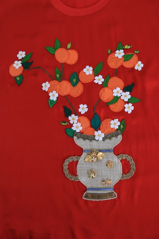 Red silk floral blouse with orange and crystal accents from Dolce & Gabbana, featuring a stylish, elegant design.