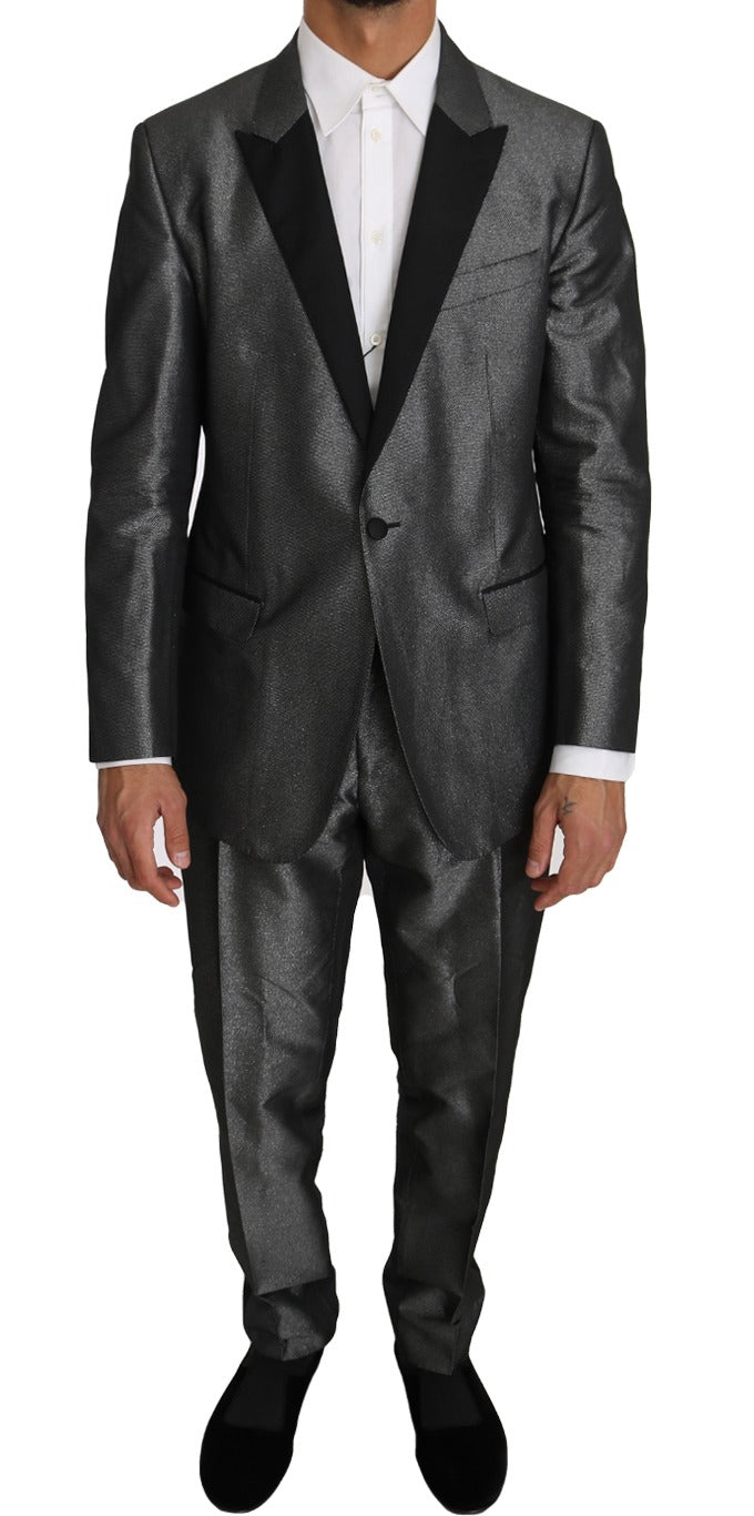 Gray patterned Martini 2-piece suit by Dolce & Gabbana, featuring tailored jacket and matching trousers on a model.