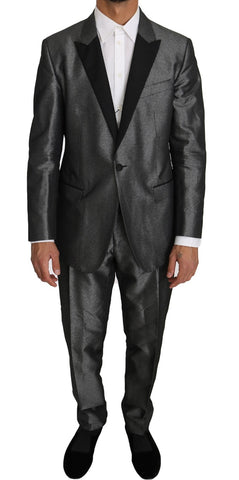 Gray patterned Martini 2-piece suit by Dolce & Gabbana, featuring tailored jacket and matching trousers on a model.