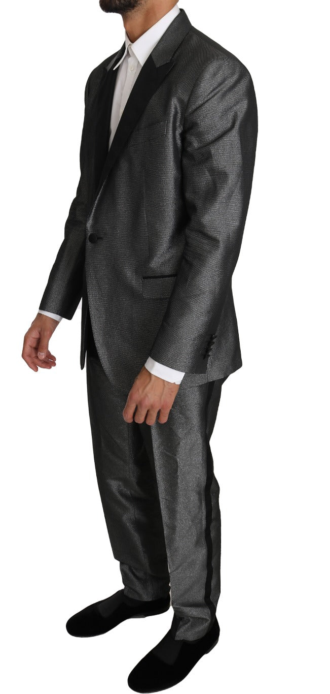 Gray patterned Martini 2-piece suit by Dolce & Gabbana, featuring tailored blazer and matching trousers on a mannequin.