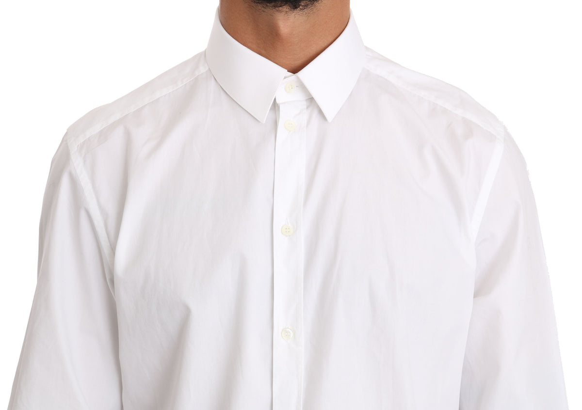 White cotton dress shirt by Dolce & Gabbana featuring a classic fit and gold accents, displayed on a hanger.