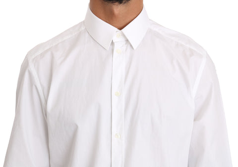 White cotton dress shirt by Dolce & Gabbana featuring a classic fit and gold accents, displayed on a hanger.