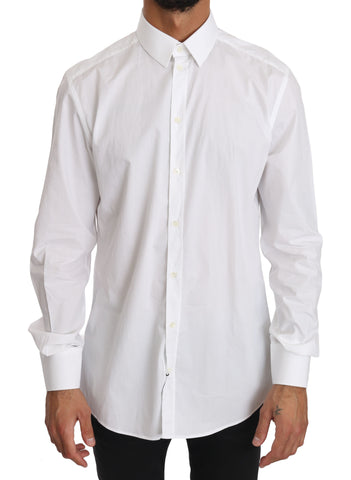 White cotton dress shirt by Dolce & Gabbana, featuring a classic fit and gold accents, displayed on a hanger.
