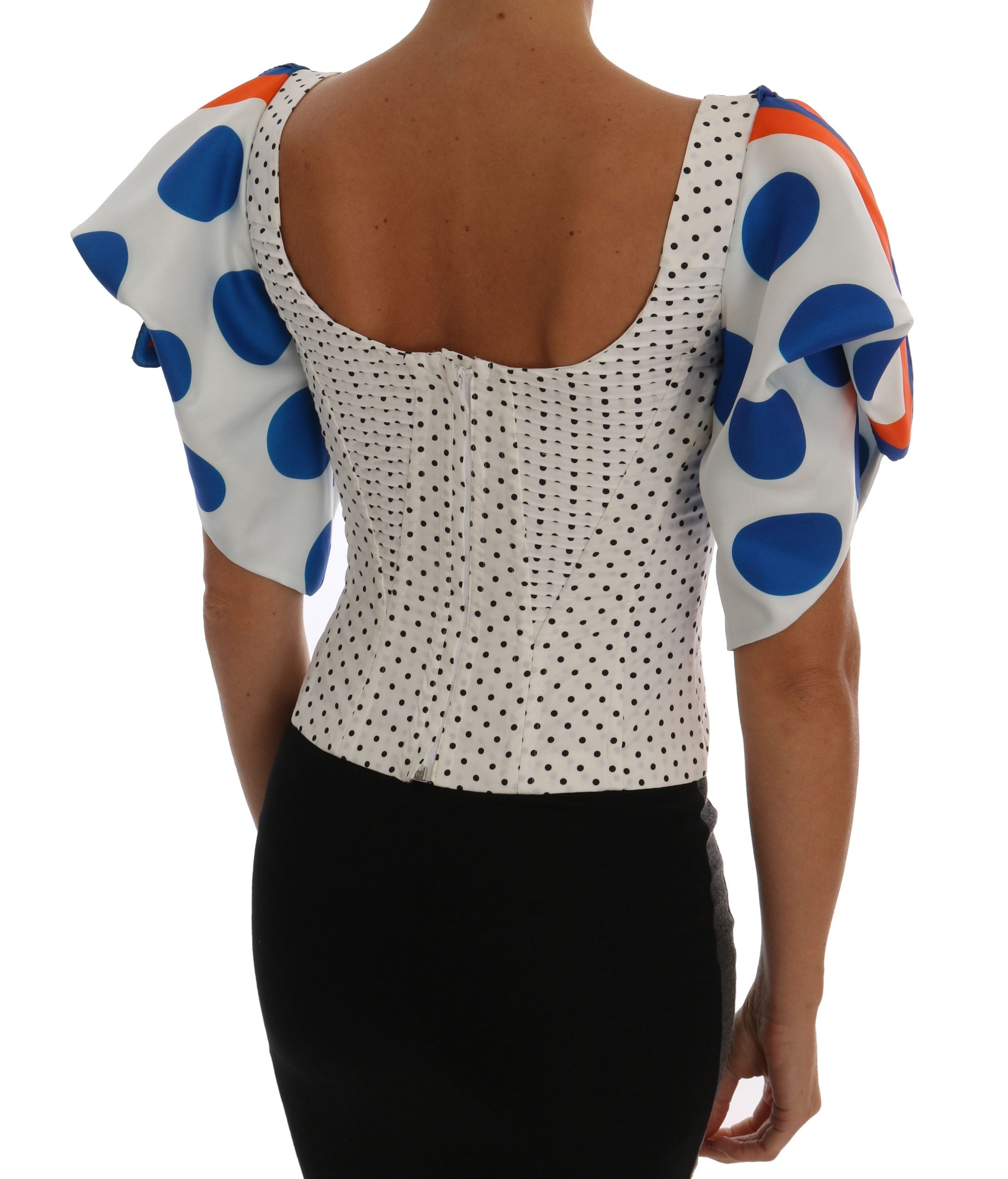 White silk corset bustier top with black polka dots, designed by Dolce & Gabbana, featuring a fitted, strapless style with lace trim.
