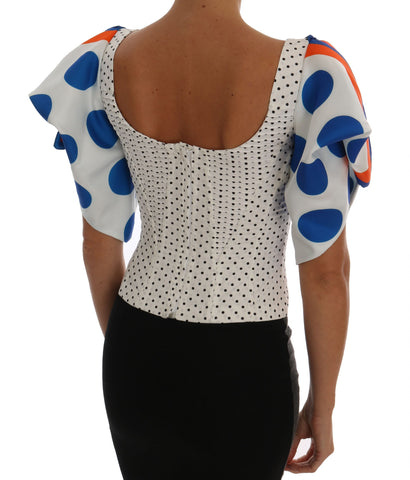 White silk corset bustier top with black polka dots, designed by Dolce & Gabbana, featuring a fitted, strapless style with lace trim.