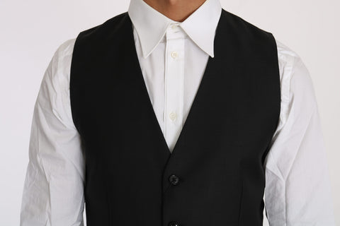Black solid wool silk waistcoat vest by Dolce & Gabbana, featuring tailored fit and classic design, shown on a mannequin.