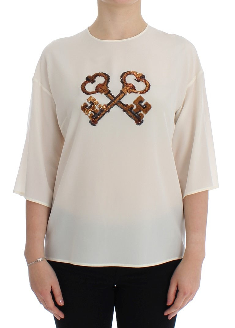 White sequined silk blouse by Dolce & Gabbana featuring a key design and T-shirt style with elegant sequined details.