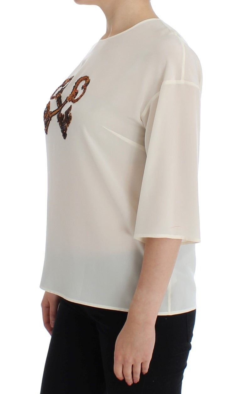 White sequined silk blouse featuring key design details, perfect for elegant occasions, by Dolce & Gabbana.