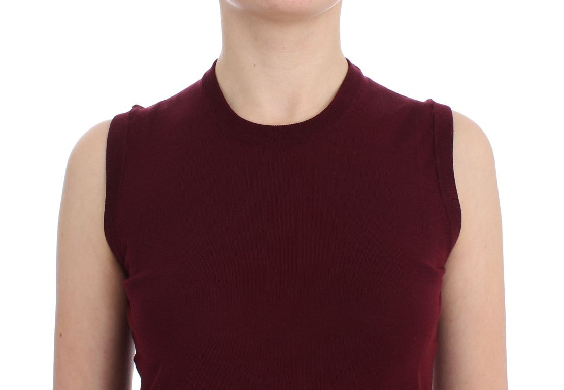 Red sleeveless crewneck vest pullover by Dolce & Gabbana, shown flat with a close-up of the fabric and neckline details.