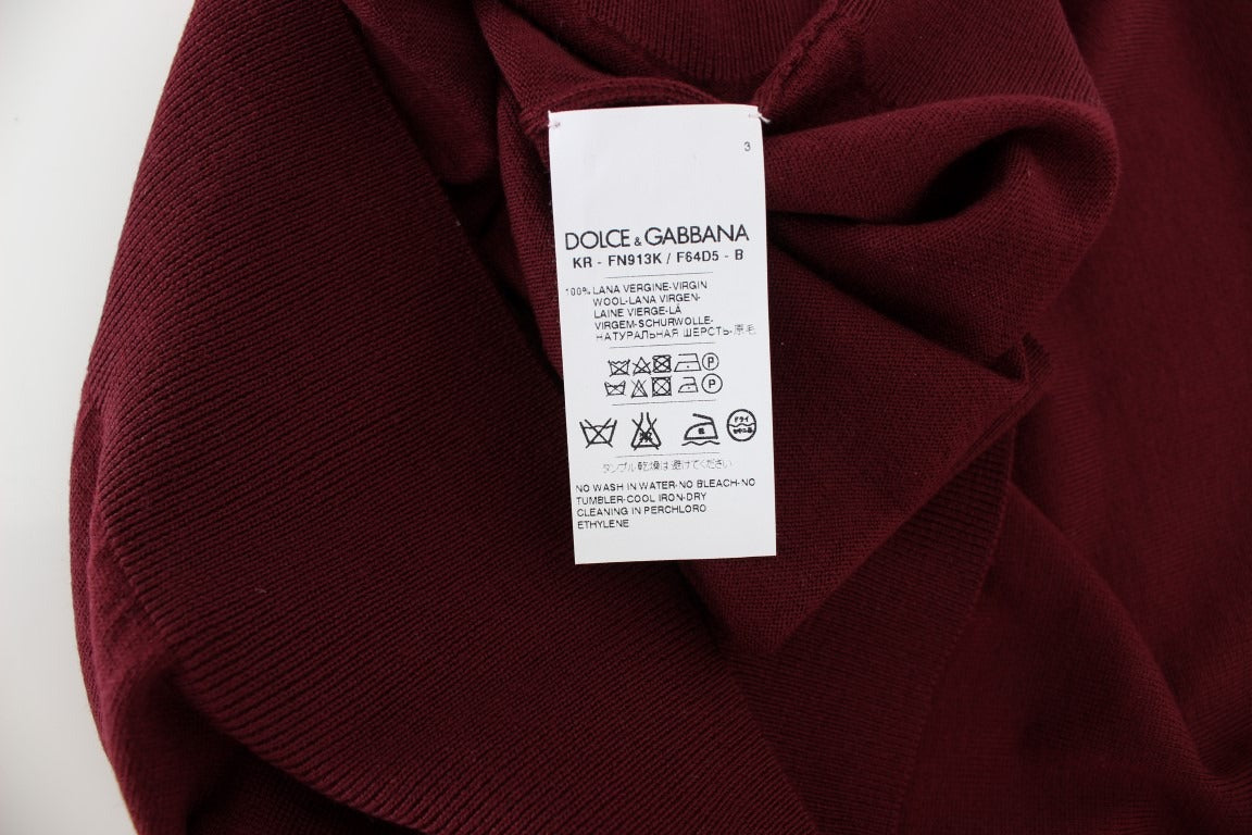 Red sleeveless crewneck vest pullover by Dolce & Gabbana on a mannequin, close-up of the stylish knit fabric.