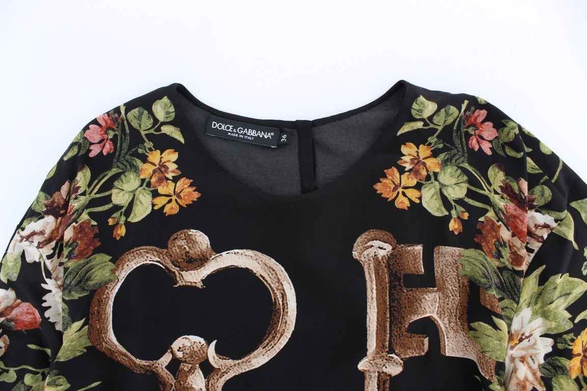 Black floral print silk blouse top by Dolce & Gabbana, featuring a stylish key pattern and elegant long sleeves.