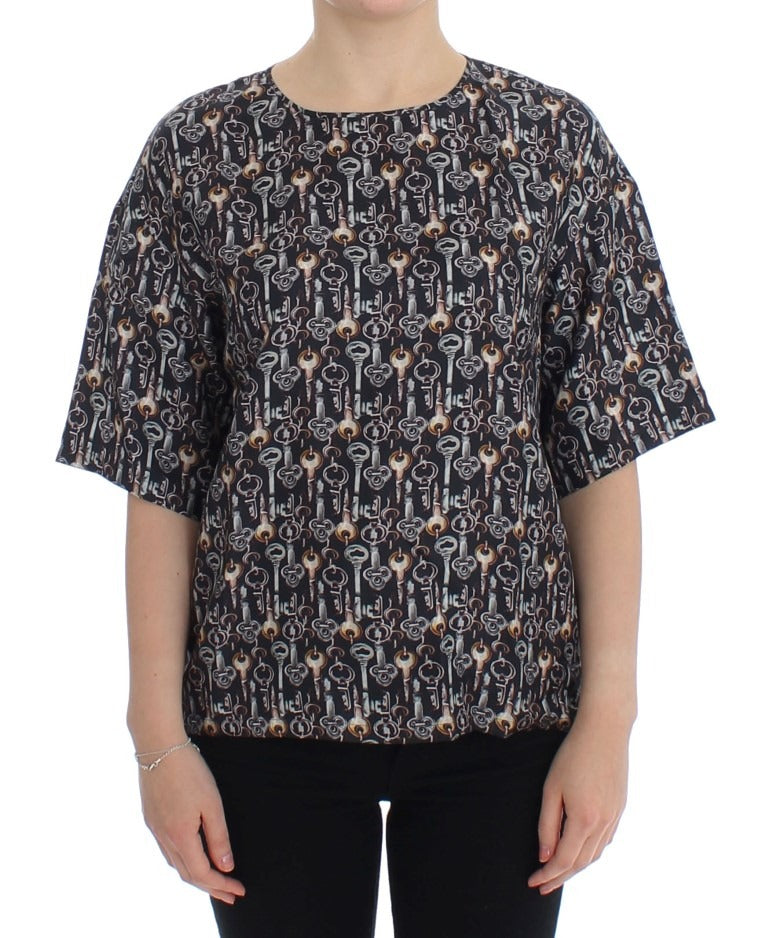 Gray silk blouse with gold key print from Dolce & Gabbana, featuring a relaxed T-shirt style and elegant design.
