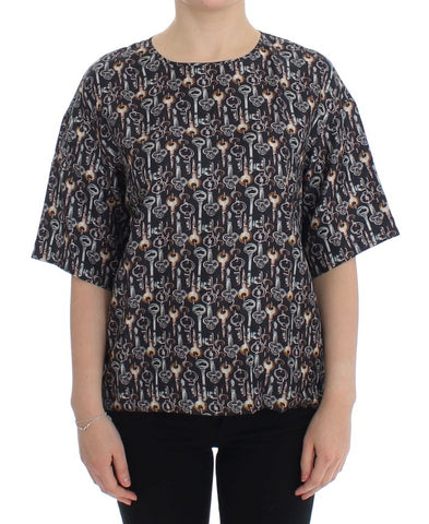 Gray silk blouse with gold key print from Dolce & Gabbana, featuring a relaxed T-shirt style and elegant design.