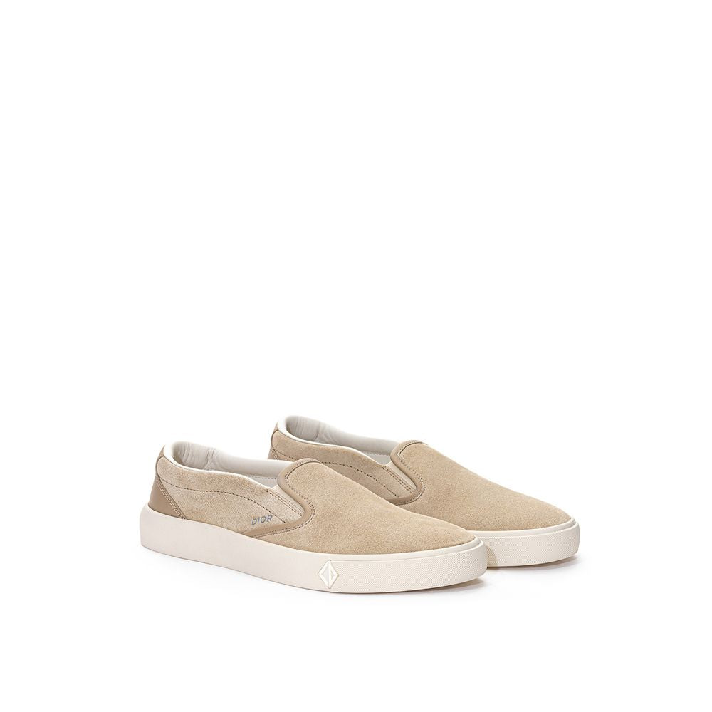 Beige leather slip-on loafers by Dior with sleek design and stitching details, stylish footwear for casual or formal wear.