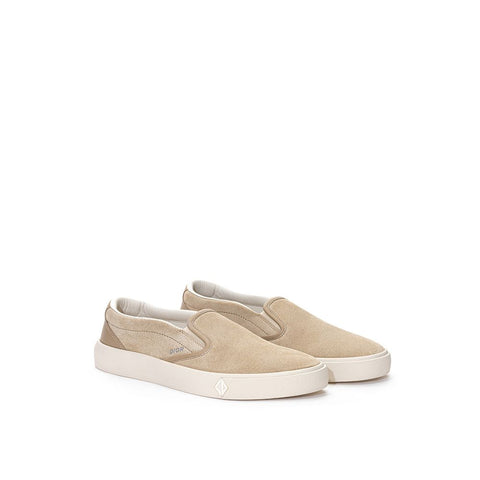 Beige leather slip-on loafers by Dior with sleek design and stitching details, stylish footwear for casual or formal wear.
