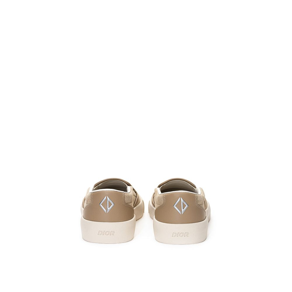 Beige leather Dior slip-on loafers with sleek design and smooth finish, casual yet stylish footwear for men or women.