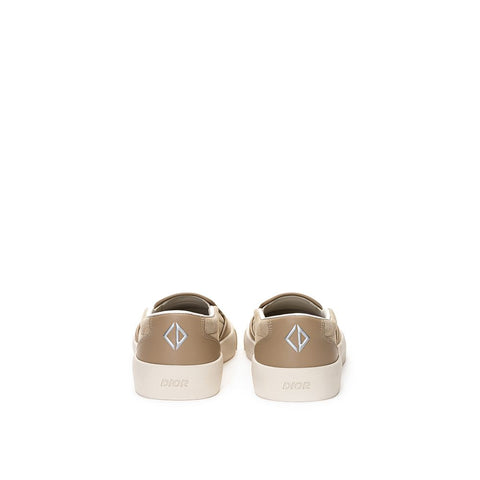 Beige leather Dior slip-on loafers with sleek design and smooth finish, casual yet stylish footwear for men or women.