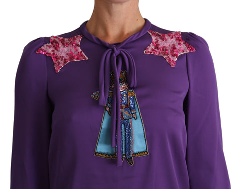 Purple Dolce & Gabbana blouse with fairy tale embellishments, featuring a stylish, elegant top with intricate detailing.