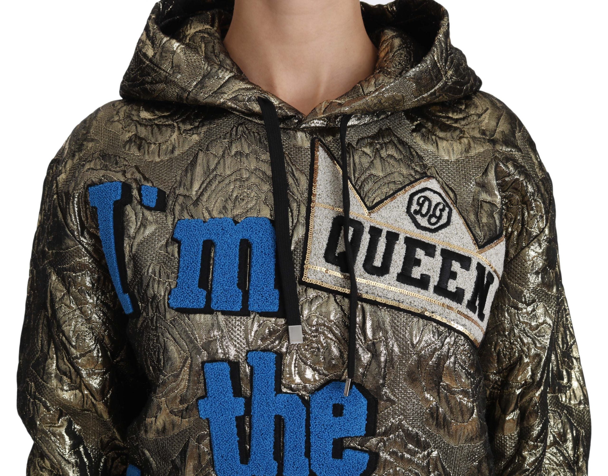 Dolce & Gabbana Im The Queen jacquard gold sweatshirt hoodie with bold text and intricate gold and black pattern.