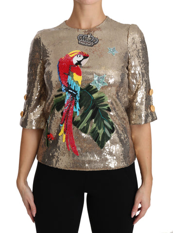 Gold sequined parrot crystal blouse by Dolce & Gabbana featuring vibrant bird embroidery and shimmering embellishments.