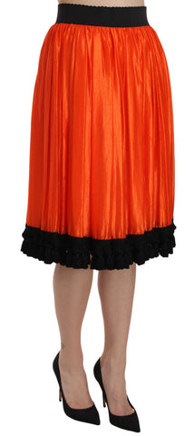 Orange high waist knee-length skirt by Dolce & Gabbana, showing its fitted waist and flowy fabric in a stylish design.