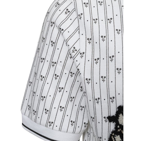 White cotton polo shirt from Jag Couture London - New York, featuring a classic collar and short sleeves.